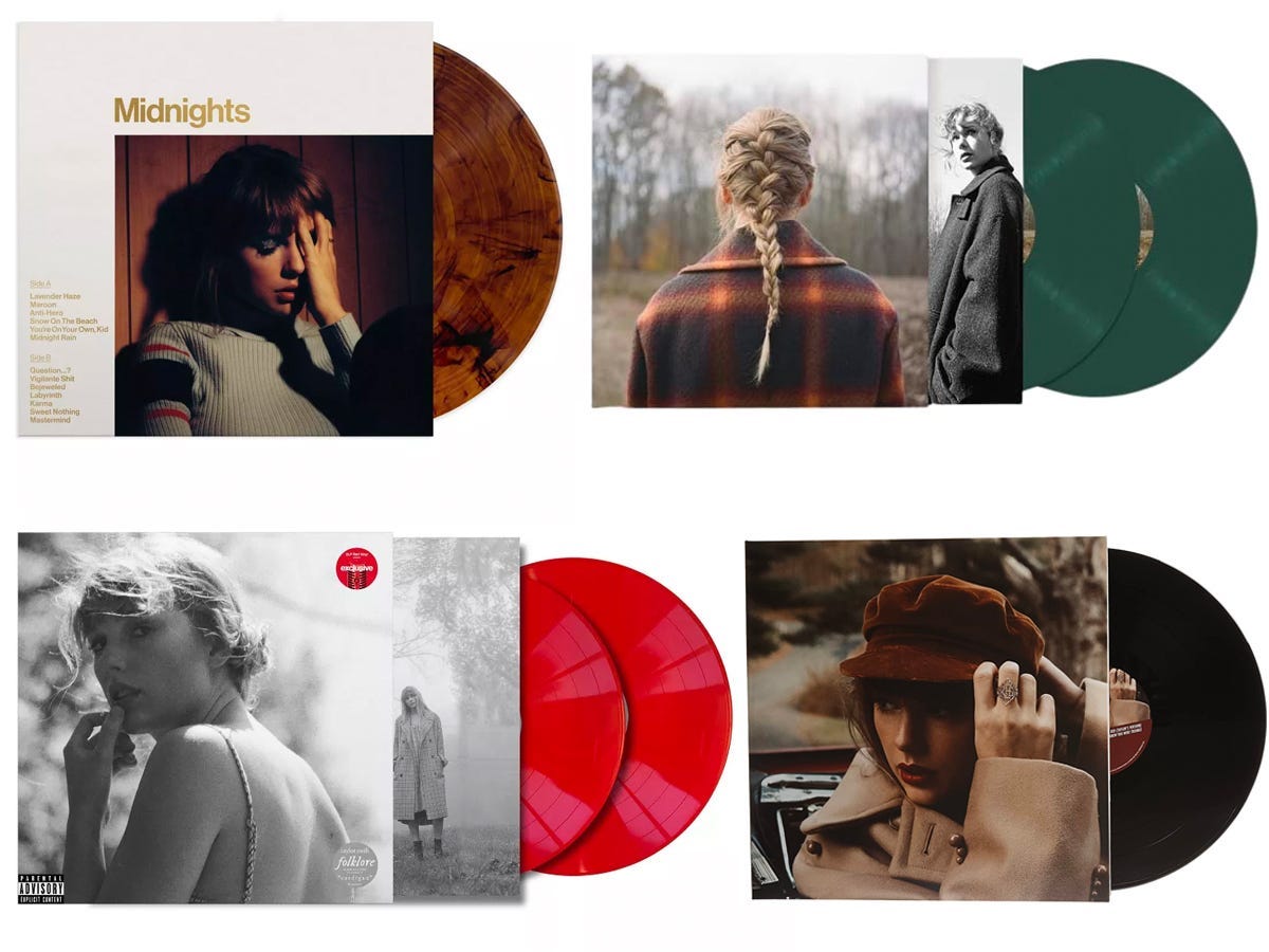 Four Taylor Swift vinyl albums, including "Midnights," "folklore," "evermore," and "Red."