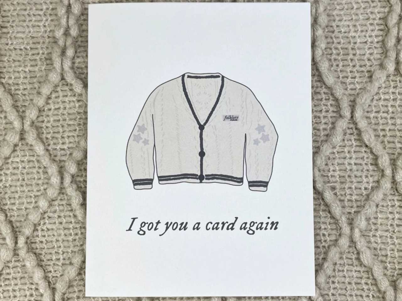 a Taylor Swift themed birthday card with an illustration of a cardigan that say "I got you a card again," one of the best gifts for a Taylor Swift fan