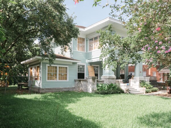 Before: The exterior had been covered over with seafoam green siding, and the porch extended past its original footprint.