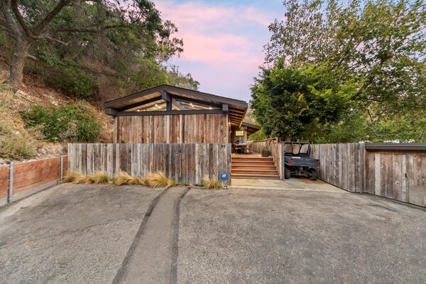 Nestled at the end of a quiet cul-de-sac, the two-bedroom residence offers one of the most peaceful lots in all of Paradise Cove, with no immediate neighbors. Rustic barn wood lining the property and a large push gate further enhance its private setting.