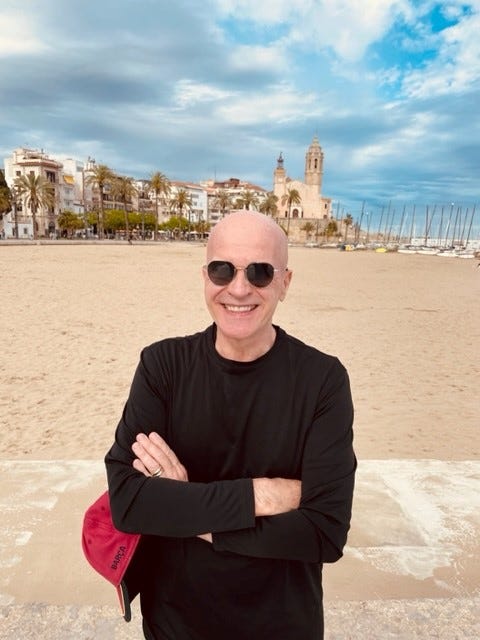 Michael Steven Grant stands on the beach in Sitges