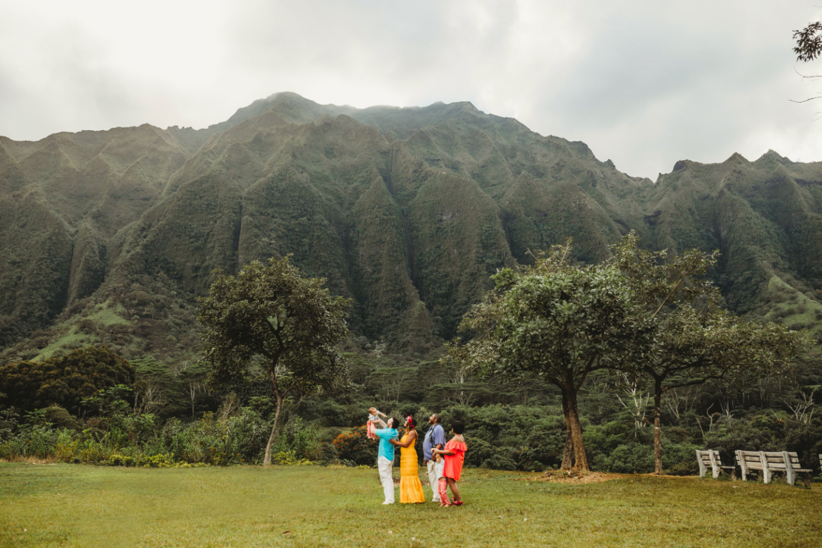 A family poses in a large field