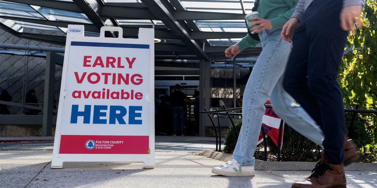 Voters attend to cast their ballots in the Senate runoff election in Atlanta, Georgia, on November 29, 2022.