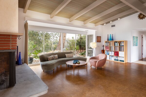 Brick, concrete, exposed wood, and cork flooring harmoniously mix in the main living room.