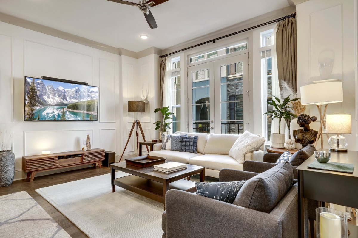 living room with furniture, large windows, and hardwood floors