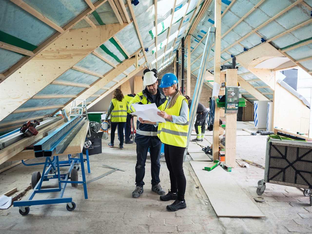 Construction managers looking over construction plans