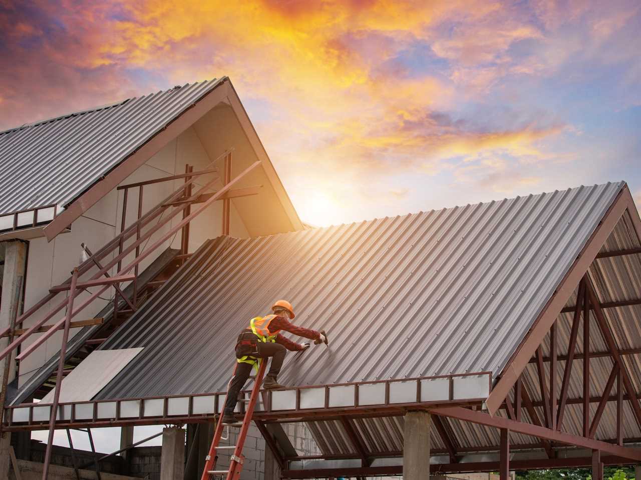 Roofer working installing metal sheet roofing