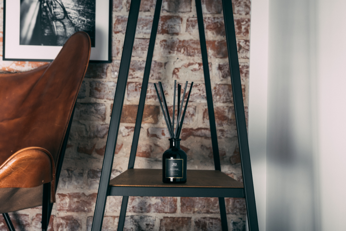 A reed diffuser on a shelf