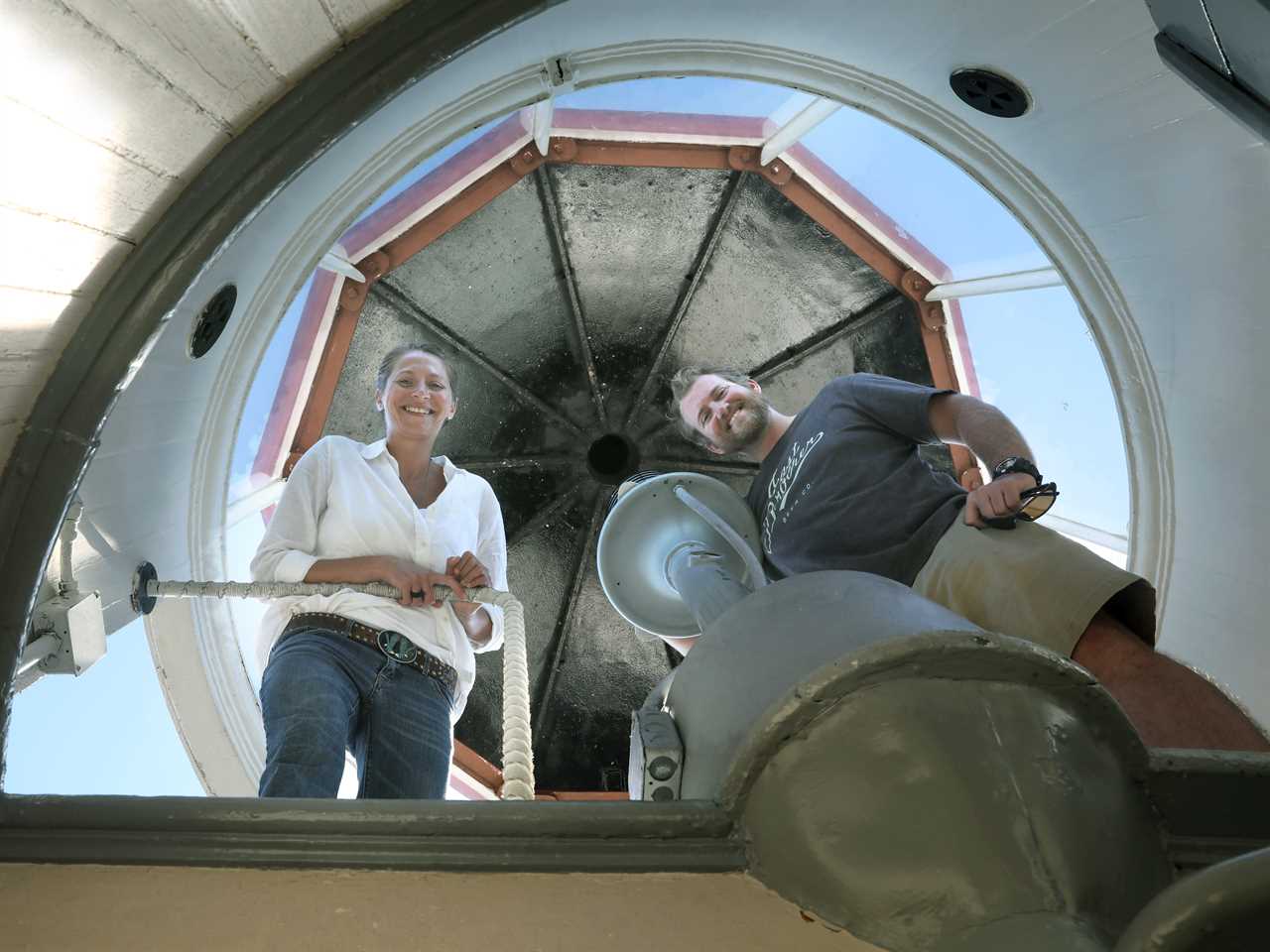 Innkeepers Tiffany Danse (top) and Tyler Waterson (bottom) show the lighthouse as they surround the lamp at the East Brother Light Station located on a small island just off Point San Pablo Harbor on Tuesday, July 23, 2019 in Richmond, Calif.