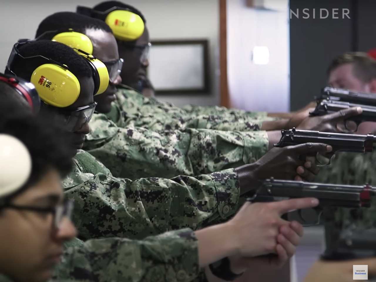 Navy recruits fire pistols during basic training.