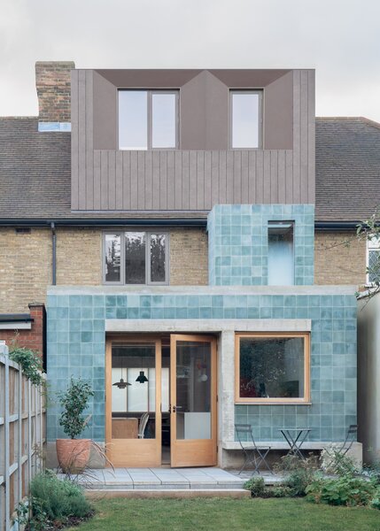 The 1930s home in London that architect Grant Straghan remodeled for himself and his family is enlivened by blue-green cement tile exterior cladding.