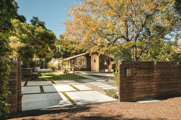 A wooden fence wraps around the historic Bungalow, which sits on a large lot in the Virginia Country Club neighborhood. Soaring trees provide ample shade, while also maximizing privacy.