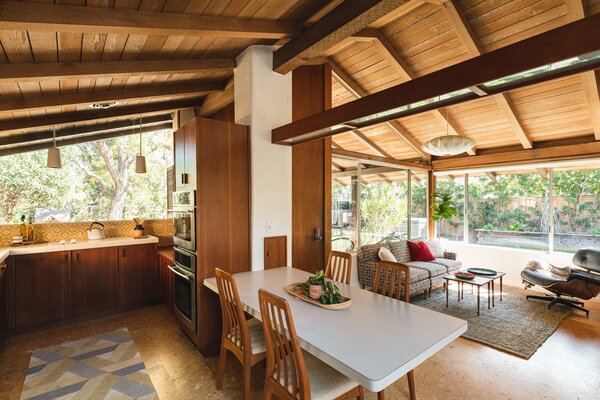 Inside, sliding glass doors and clerestory windows wrap around the main living areas, allowing the open floor-plan to be bathed in natural light. Cork flooring further unites the various spaces.