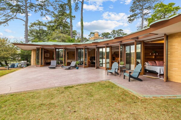 The ribbed-copper roof cantilevers over the back patio.