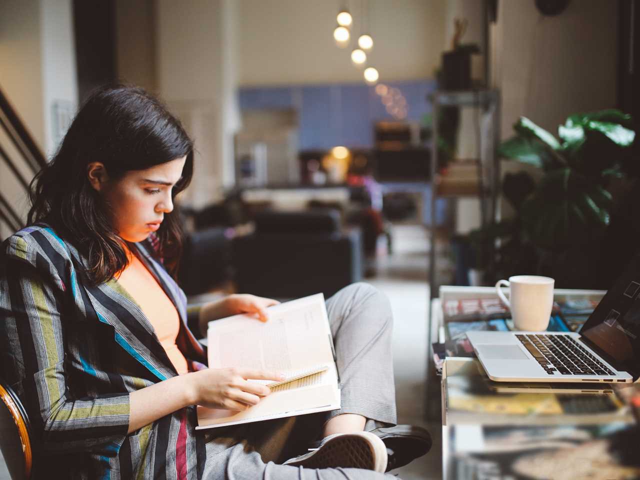 woman reading book studying