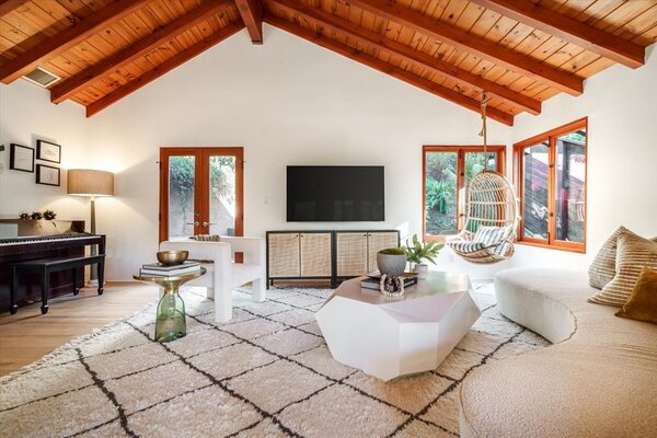 Inside, vaulted ceilings pop against the crisp white walls and honey-hued hardwood floors.