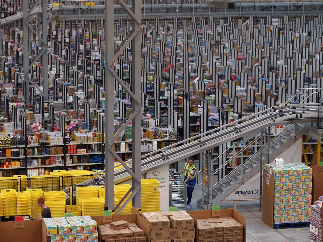 View of a large warehouse interior with rows and rows of sorting machinery.