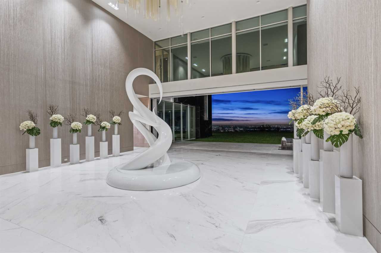 a foyer with a white sculpture in mansion The One Bel Air