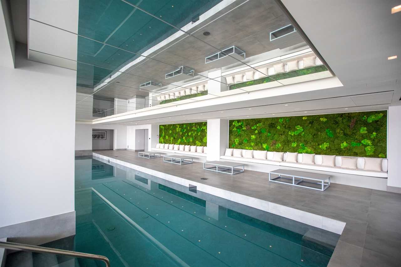 a swimming pool in a room with a mirror on the ceiling at mansion The One Bel Air