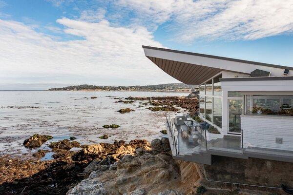 The home was named after its iconic winged roof, which cantilevers over the front deck that overlooks the Monterey Peninsula. Floor-to-ceiling windows span across the property.