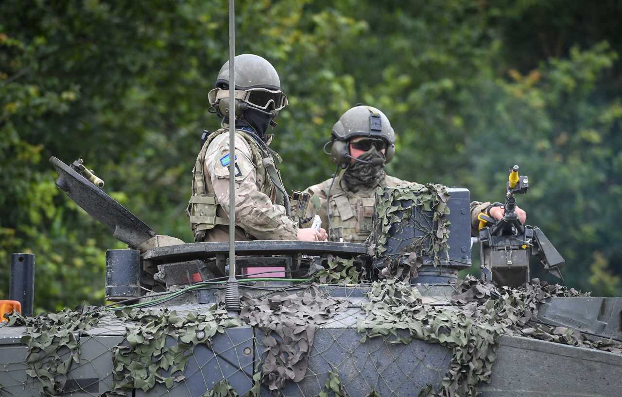 A commander, left, of a Challenger 2 Main Battle Tank during a training exercise.