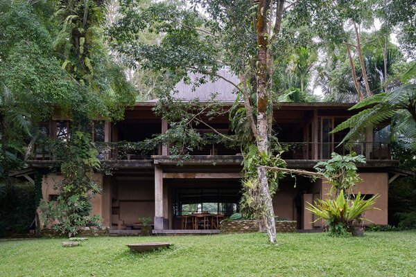 A lack of doors and walls creates a seamless integration with the forest that surrounds the home.