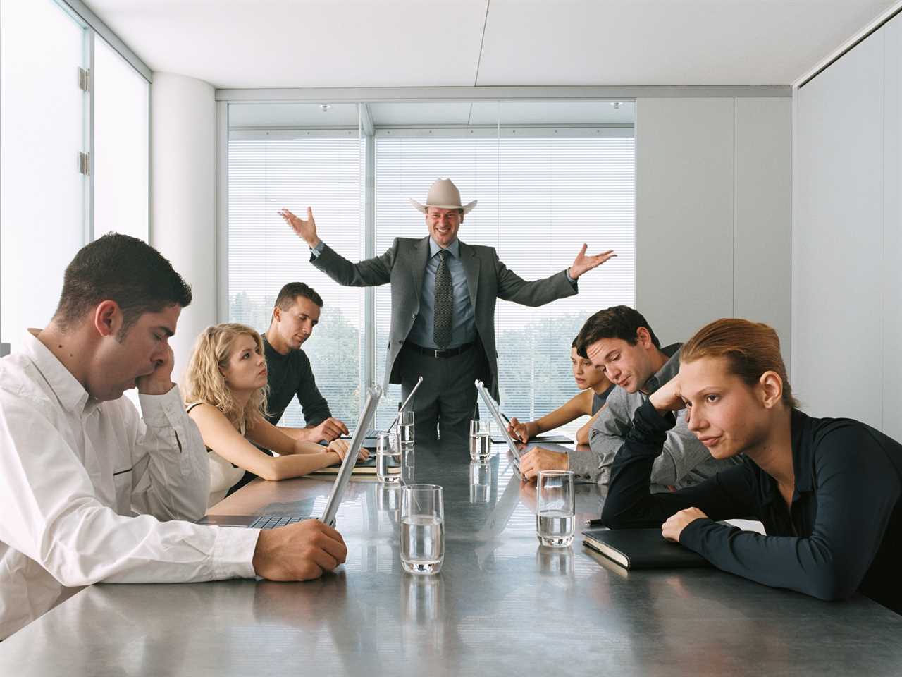 Businessman Talking to Bored Staff in Meeting - stock photo