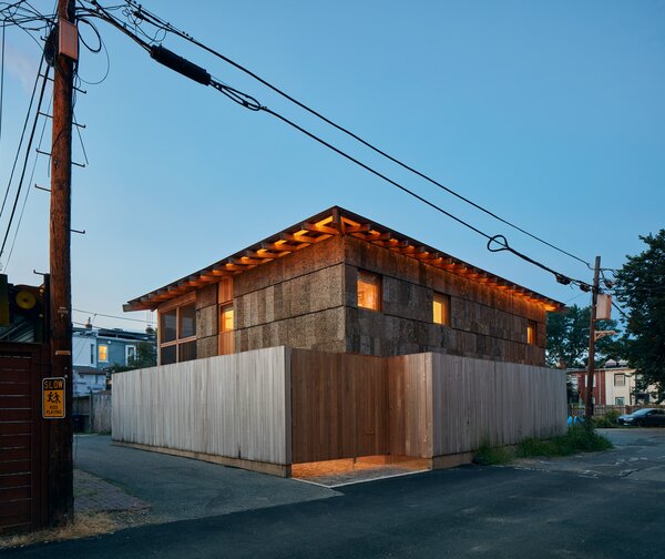 The Linns’ home, which Andrew Linn and Jack Becker completed for Andrew and his wife last year, declares its commitment to natural materials with a patchwork of wood products on its exterior. The sassafras cladding the lower portion of the house’s east face peels away from the building to become a freestanding fence enclosing a small, private outdoor space in the middle of the alley.