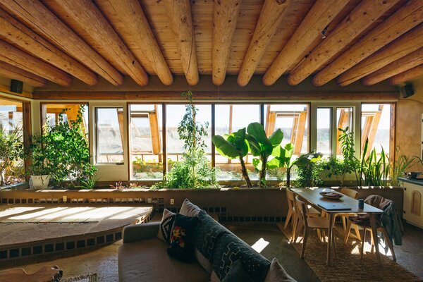 Cracked timber beams run the width of the house. These beams, called vigas, are typical of Southwestern adobe construction. 