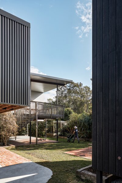 The couple chose hardy materials such as concrete blocks and galvanized steel and raised the floor 1.9 meters to keep the new build safe. The sleek, charred-wood cladding is an additional flood-resilience measure.