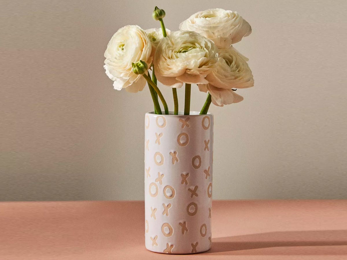 white flowers inside the Hugs and Kisses Vase with the letters "X" and "O" patterned on the ceramic.