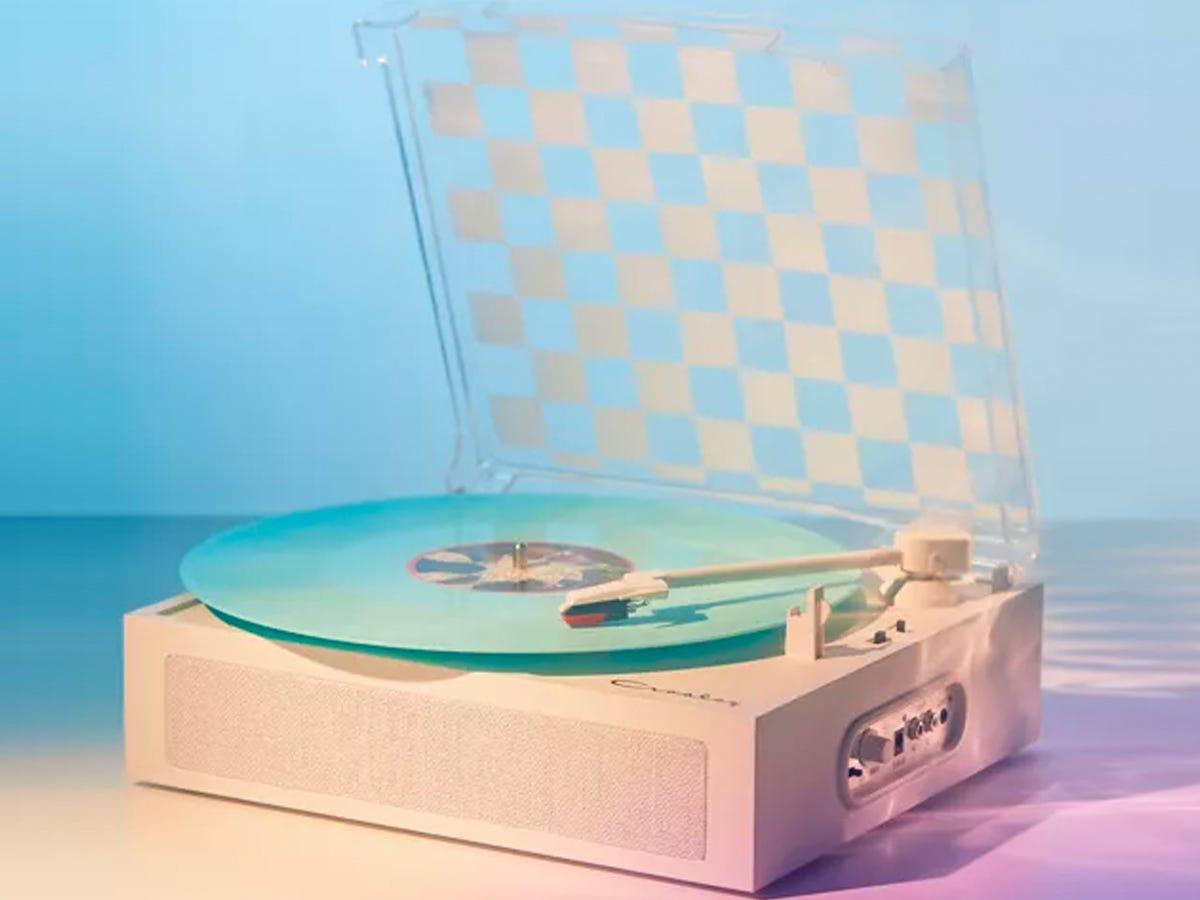 Crosley Ryder Turntable with a checkered lid playing a light blue vinyl record.