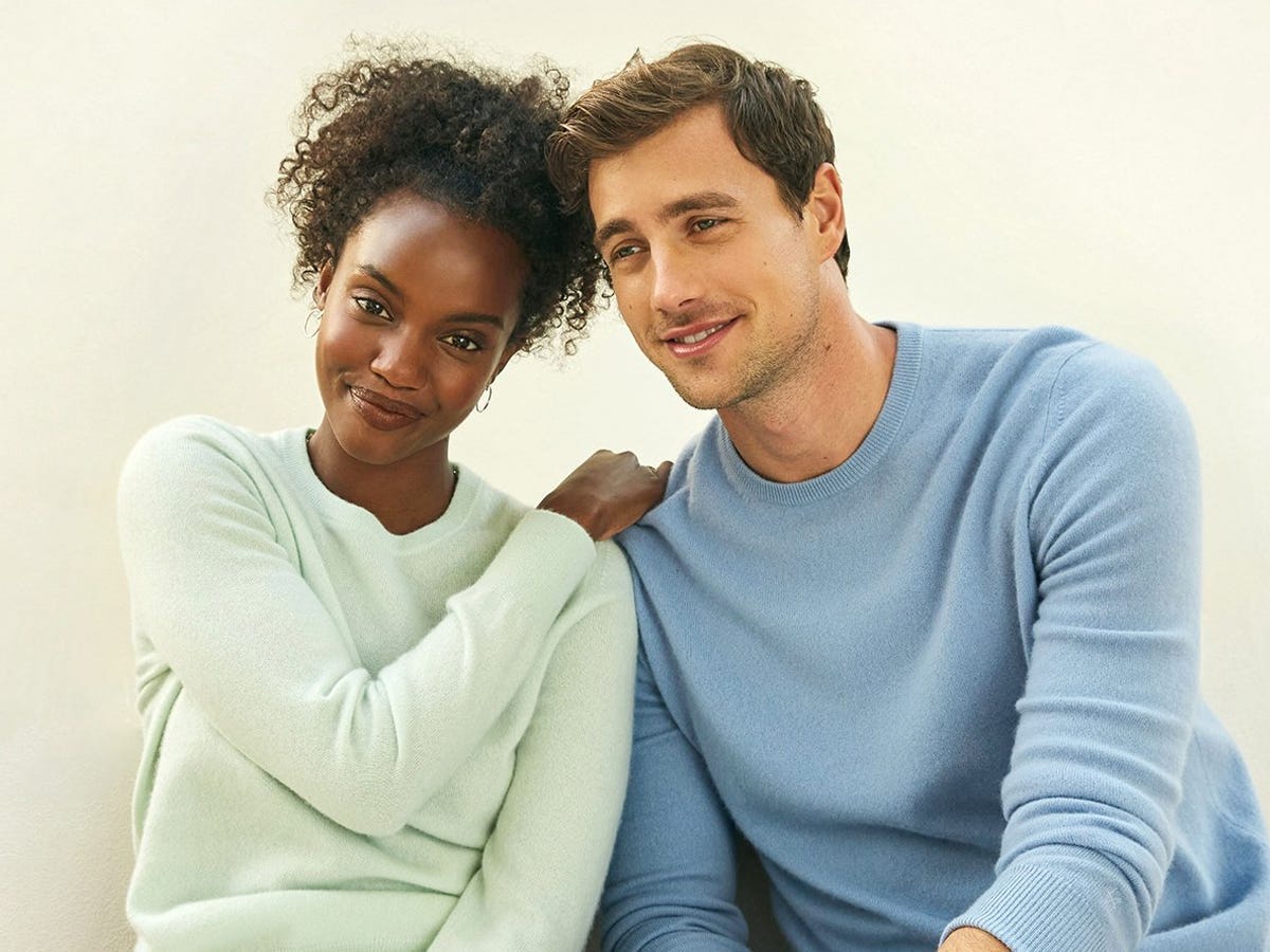 Two people wearing different colors of The Essential Cashmere Sweater from Naadam.