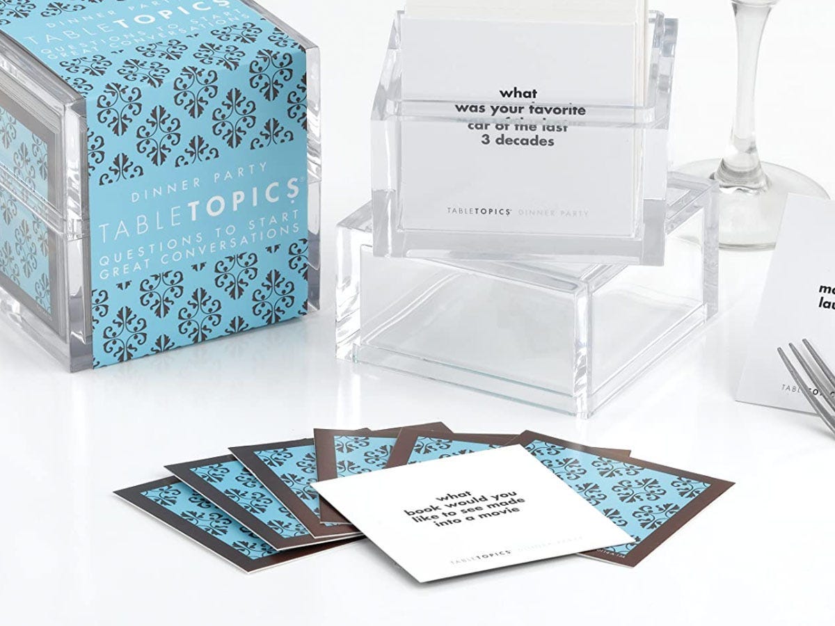 A blue box with square conversation starter cards spread out in front of it.