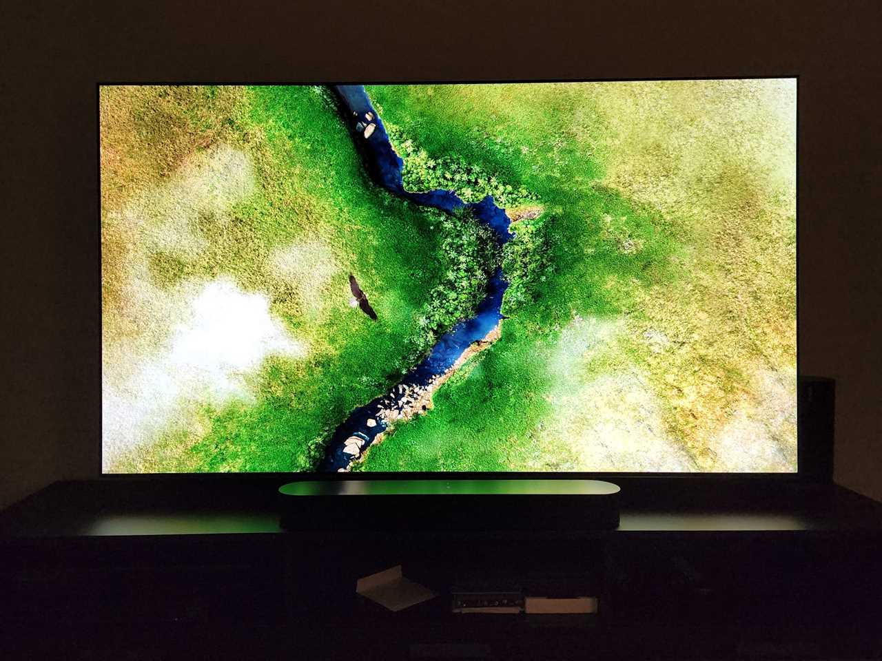 An overhead shot of a winding river on an LG G2 OLED TV