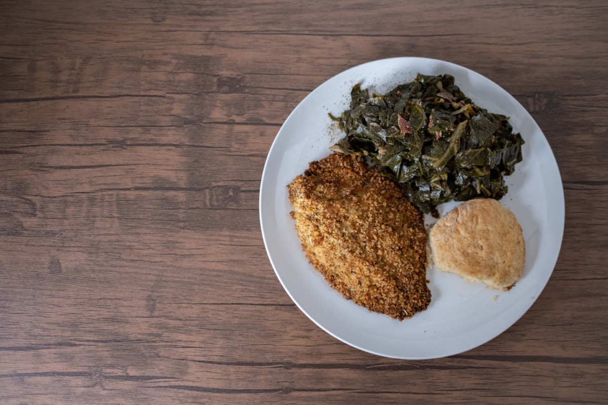 catfish plate with greens and a biscuit