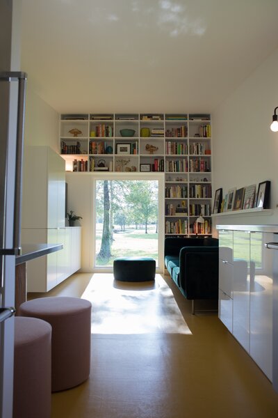 Blue Dot stools sit at the custom table. The sofa is from Joybird. Kitchen lighting was sourced from 143 Lighting. 