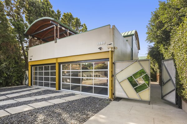 A geometric glass entry gate leads to the rear unit, which comes with its own address.