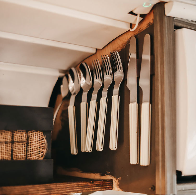 Cutlery being held up by magnetic organizers