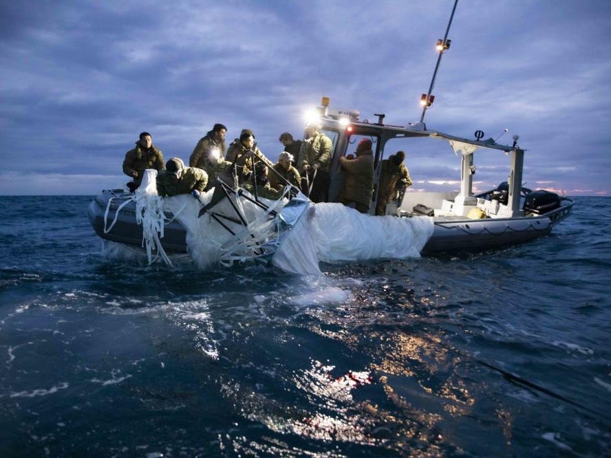 Sailors assigned to Explosive Ordnance Disposal Group 2 recover a high-altitude surveillance balloon off the coast of Myrtle Beach, South Carolina, Feb. 5, 2023.