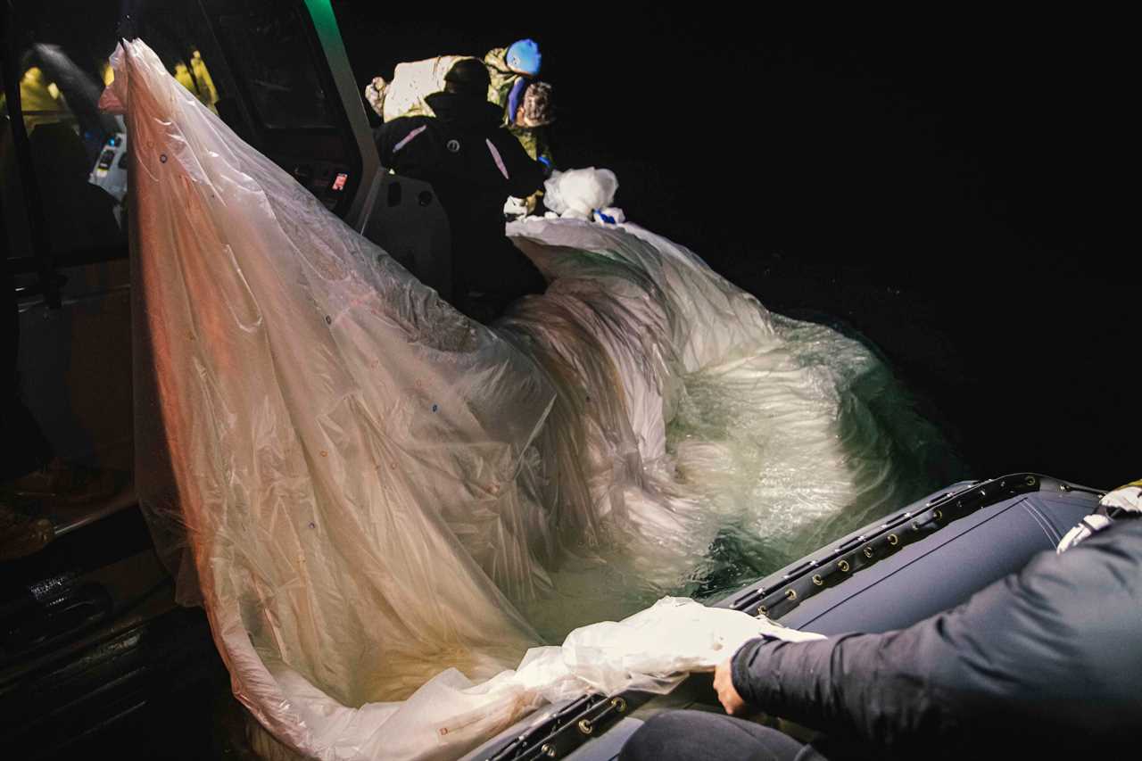 Sailors assigned to Explosive Ordnance Disposal Group 2 recover a high-altitude surveillance balloon off the coast of Myrtle Beach, South Carolina, Feb. 5, 2023.