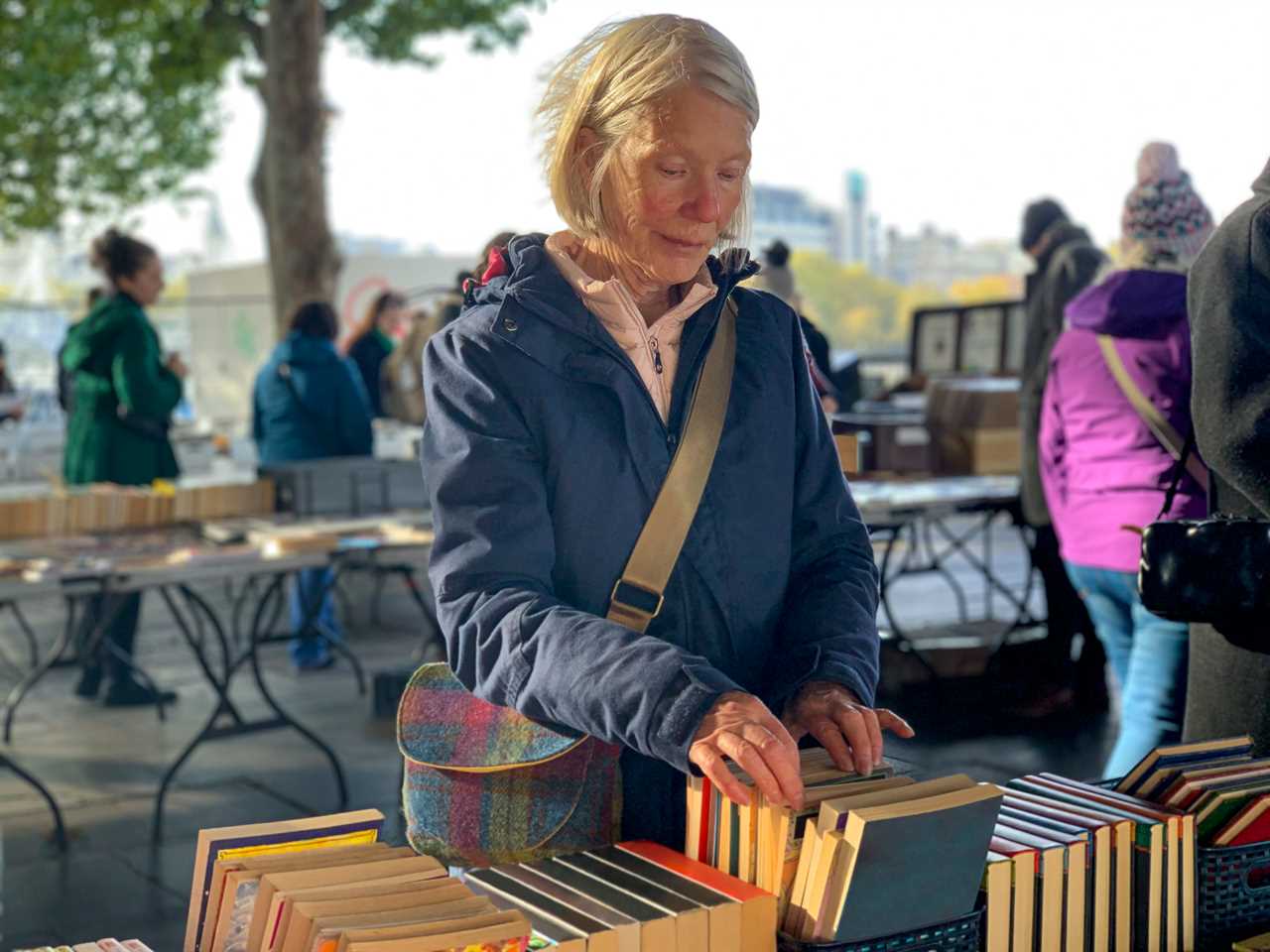 A woman shopping for a book to buy