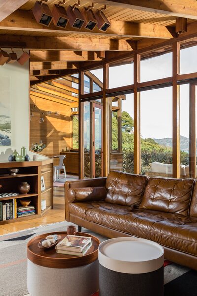 Handmade redwood windows line the back façade on the upper level, meeting a striking Douglas fir covered ceiling.