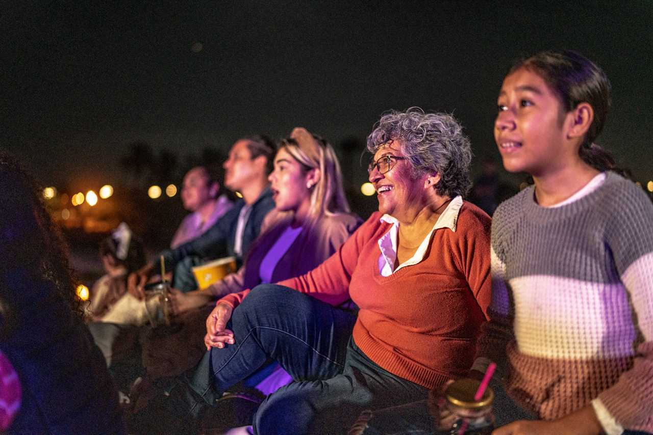 A family enjoying a cinema outdoors