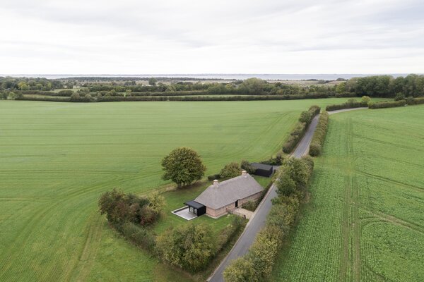 A Dilapidated 1800s Farmhouse Is Revived With a New Thatched Roof and a More Open Plan