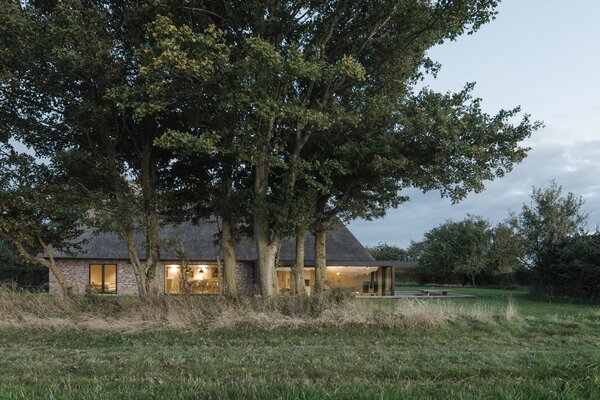 A Dilapidated 1800s Farmhouse Is Revived With a New Thatched Roof and a More Open Plan