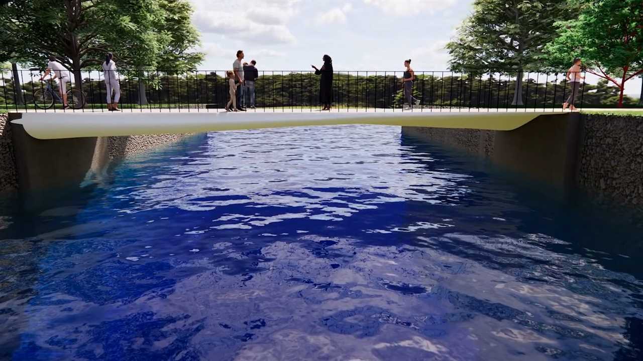 A bridge with pedestrians walking on it stretches across a blue channel of water.