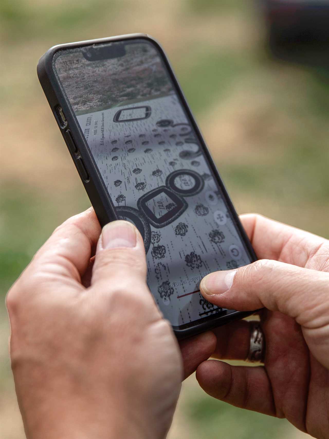 hands holding a cellphone with research app