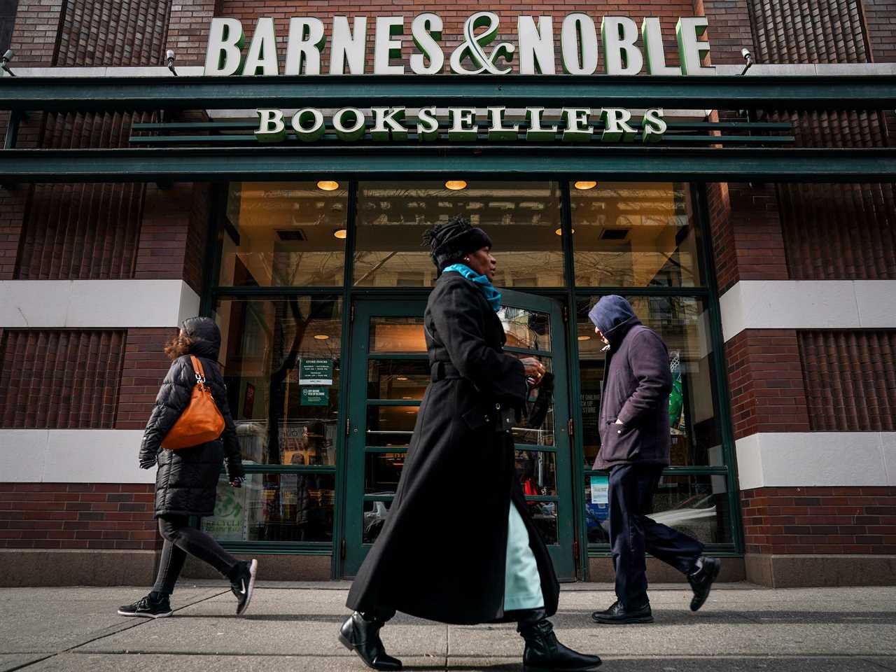 Barnes & Noble storefront in city with people walking past