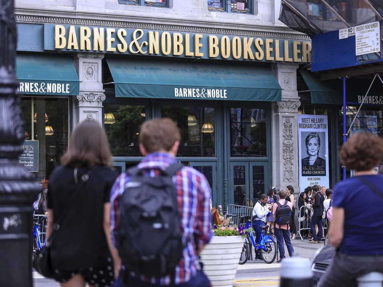 Pedestrians stand across the street from Barnes & Noble in New York City